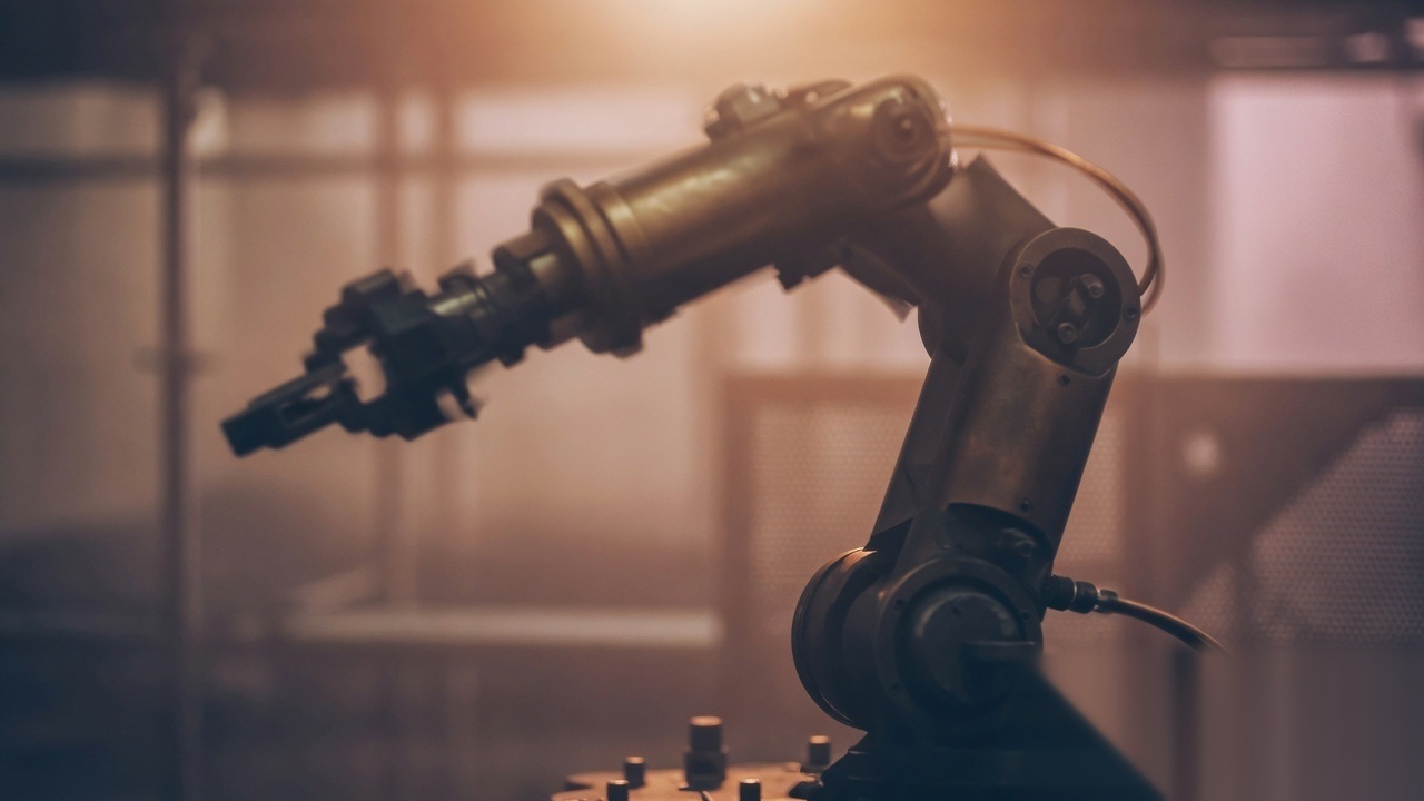 Soft industrial light on abstract robotic arm silhouette
